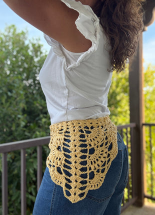 Yellow crochet bandana worn as a hip scarf with jeans and a white top.