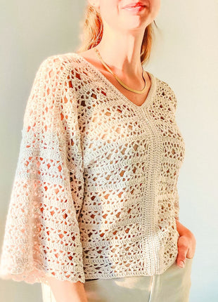 Front angled view of the cream Magnolia Cardigan showing the V-neck, buttoned front, and lace texture.