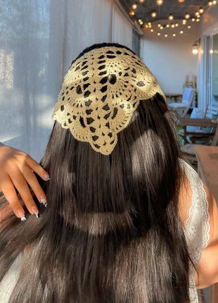 Back view of a yellow crochet bandana worn over long dark hair.